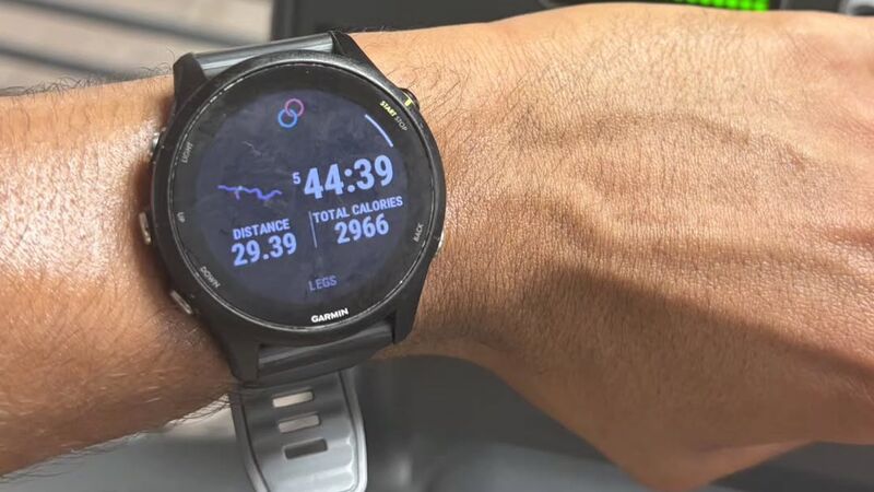 A running watch on Carlos’s wrist reading 29.39 miles in 5 hours 44 minutes 39 seconds.